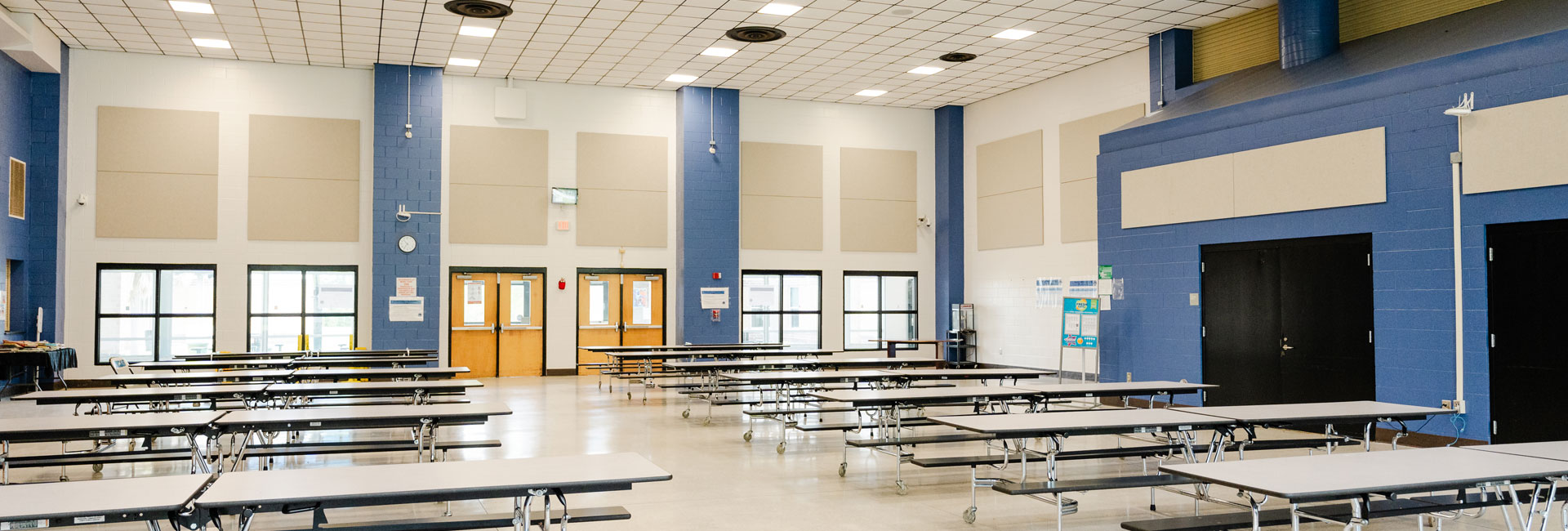 blue accent walls with cream surrounding walls at a large cafeteria in the Beaufort County School District Whale Branch Middle School