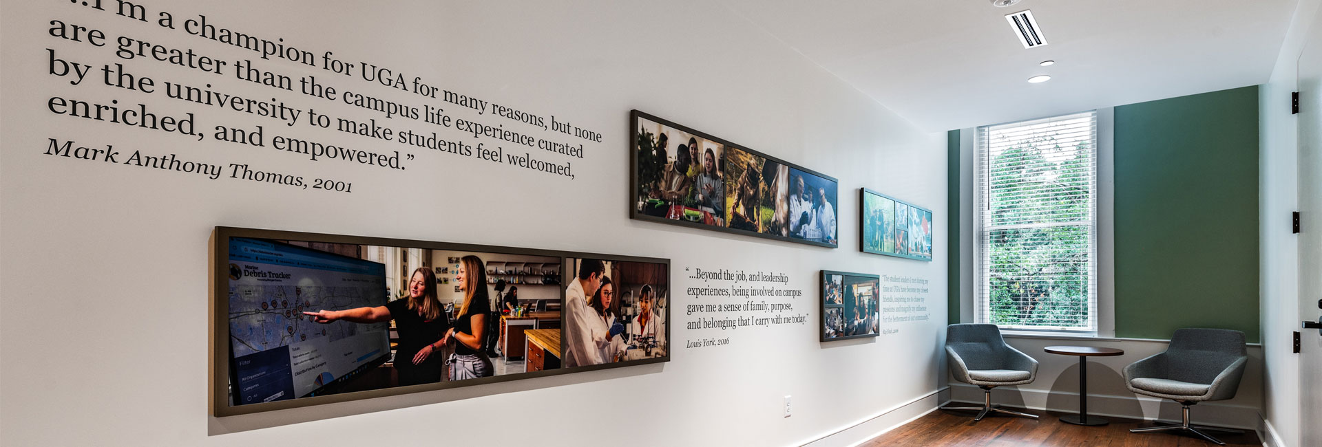 sitting area with images on the wall and green accent wall at UGA